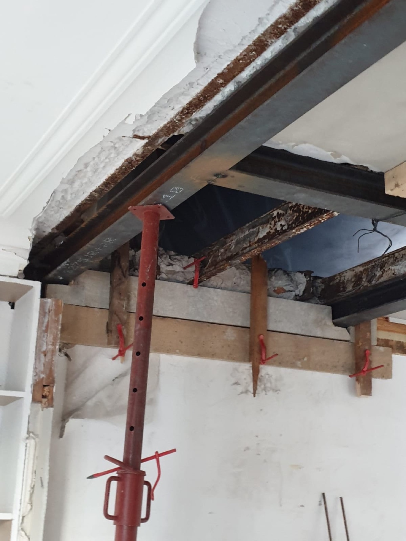 Étais métalliques sous un plancher ouvert.